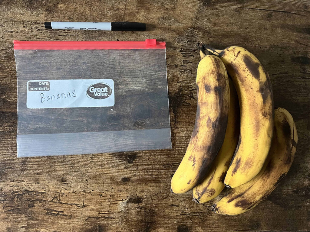 Overripe bananas next to a baggie. 