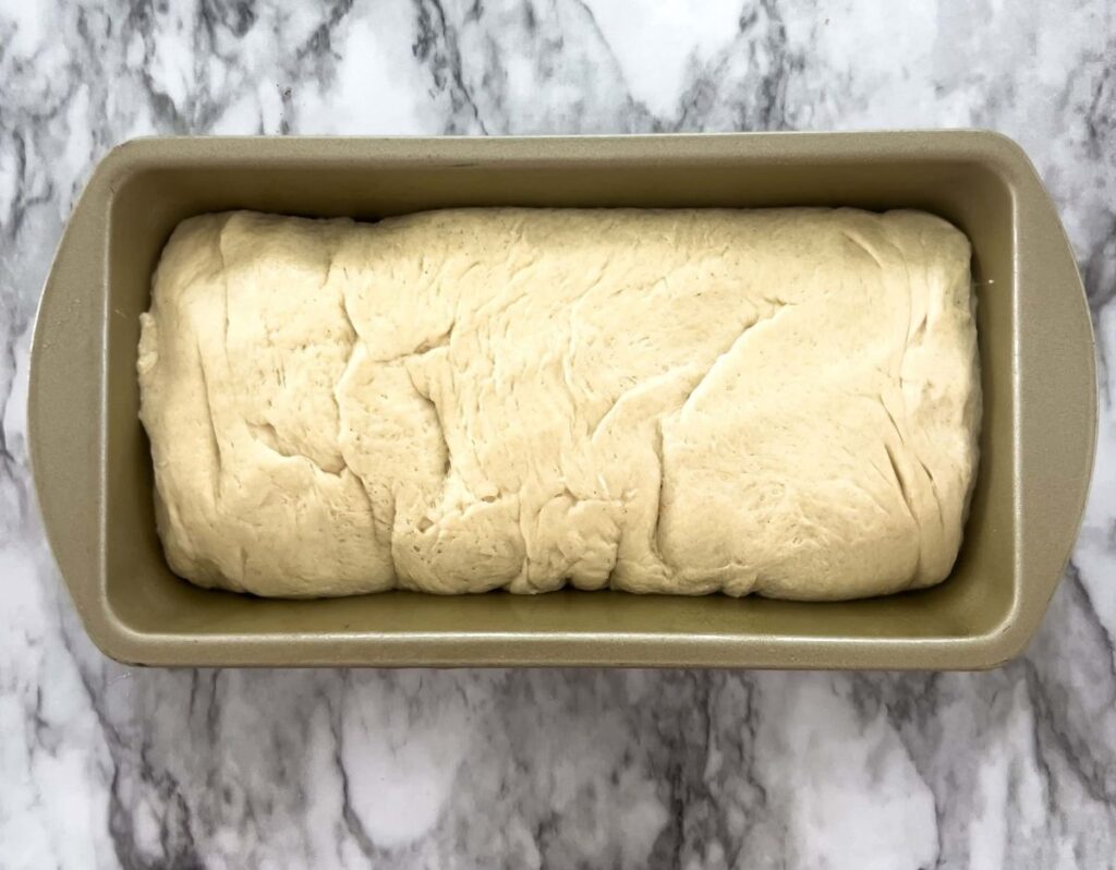 Sourdough shaped to fit a metal bread pan.
