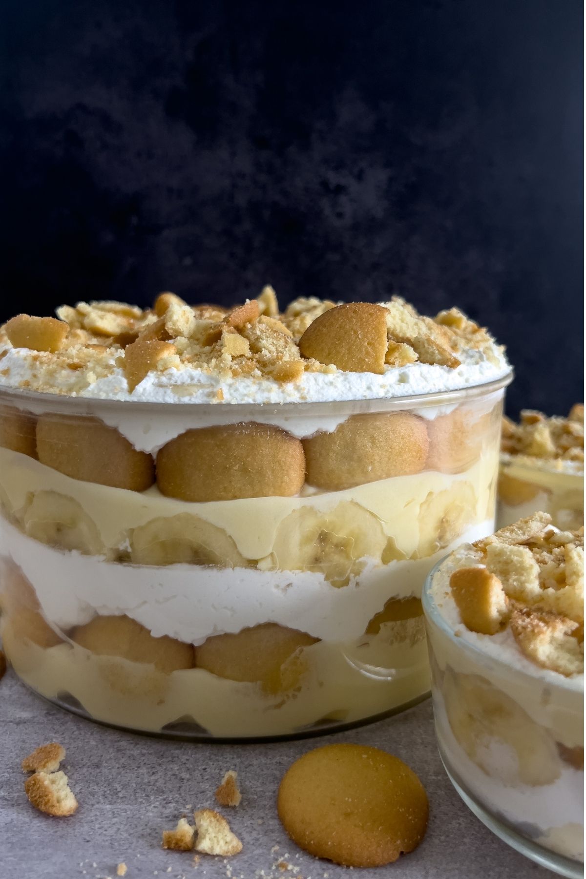 A image of the trifle bowl of the best southern banana pudding which shows layers of pudding, vanilla wafers, and bananas.
