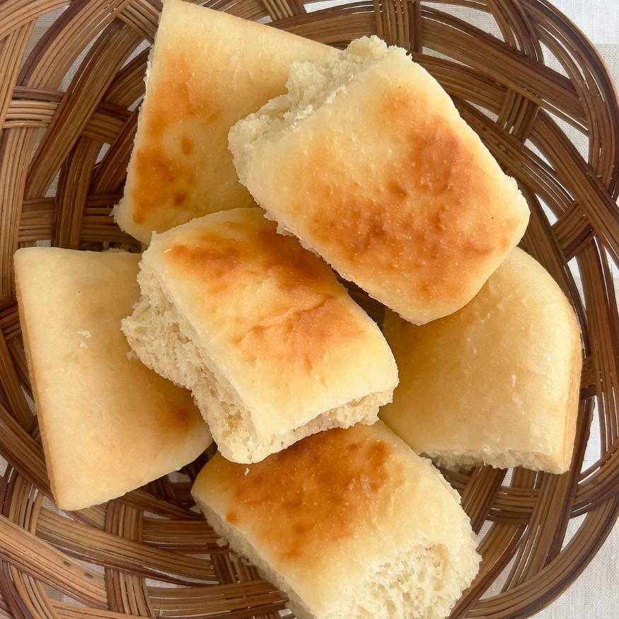 A brown basket of easy one day sourdough Texas roadhouse rolls.