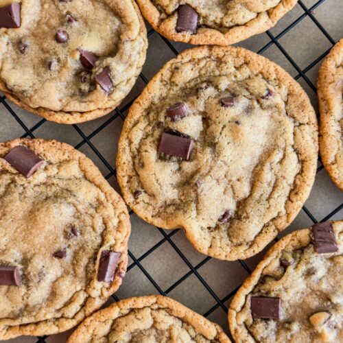 Magnolia style chocolate chip cookies on a baking rack